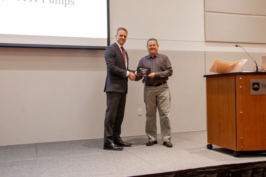 Dr. Brian Knetl, President of Waubonsee Community College (L) presents the 2023 Outstanding Contributor Award to Tim Tremain, President of MTH Pumps 