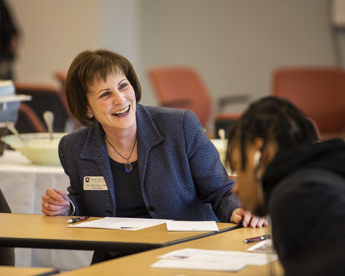 Dr. Sobek smiles with student