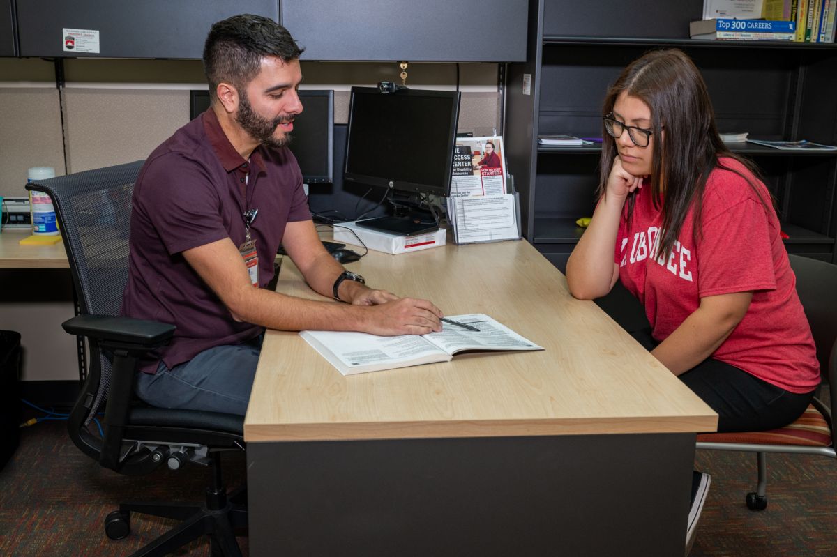 Advisor helping student with catalog