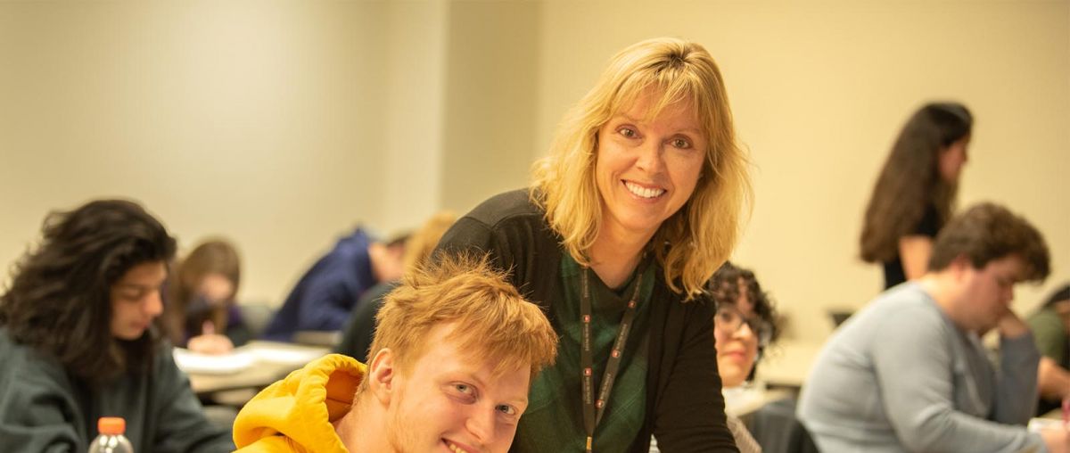 Kathleen Randall - Professor of Education helping a student in class