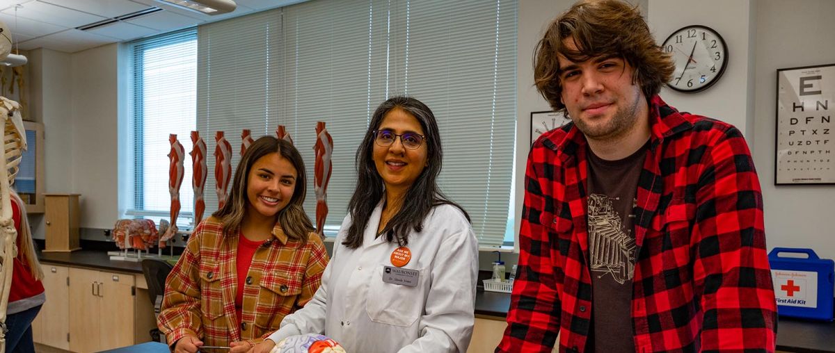 Dr. Sheela Vemu, Associate Professor of Biology with two students in a lab