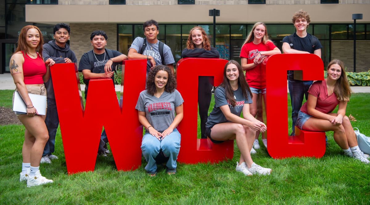 Students gathered around giant WCC letters outside