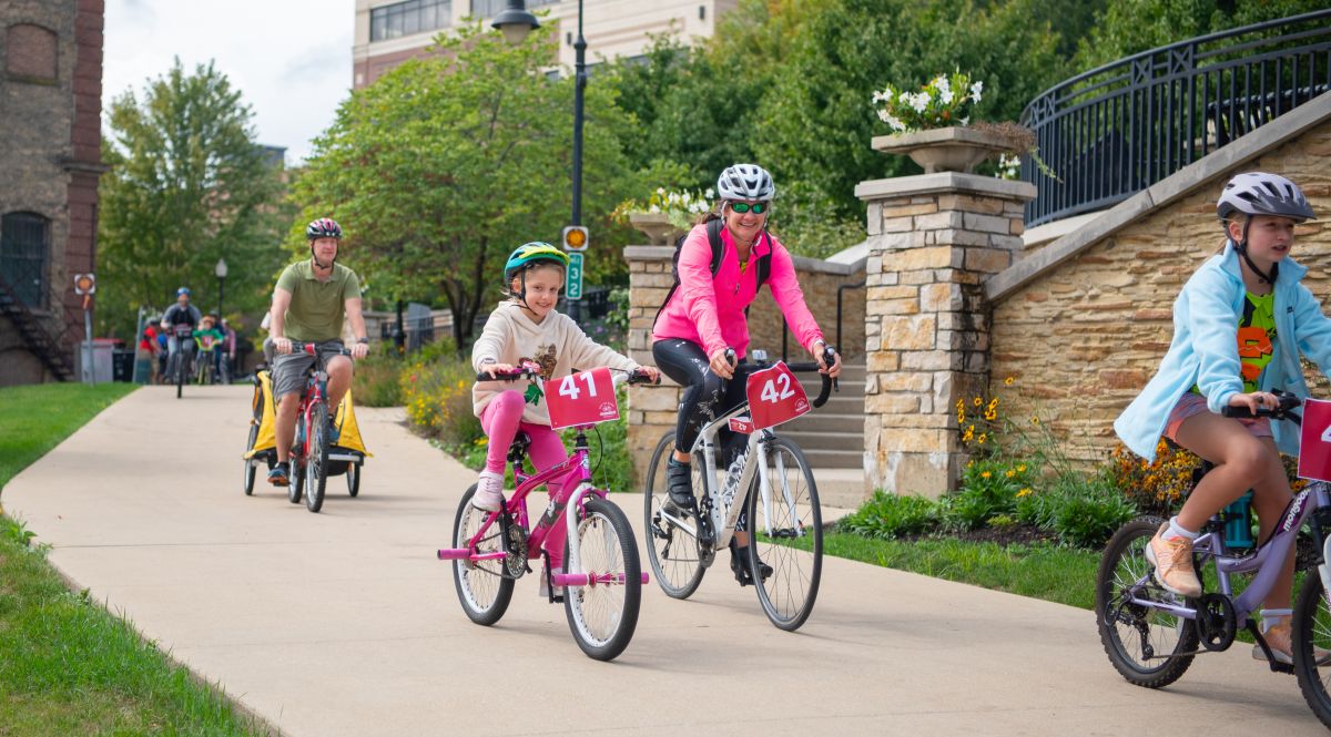 Bike riders on the path near Aurora Downtown campus