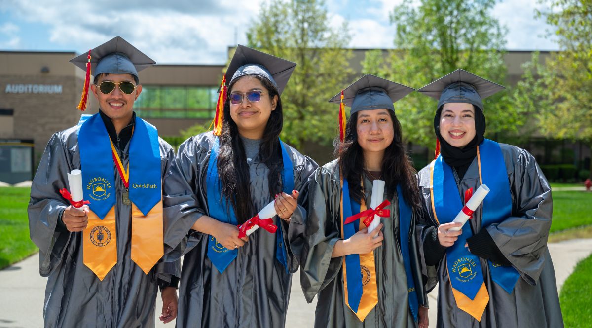 Four Quickpath Graduates standing outside