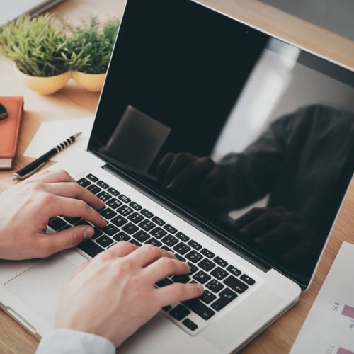 person on laptop with coffee s