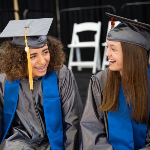 Two female Quickpath Graduates sitting and smiling