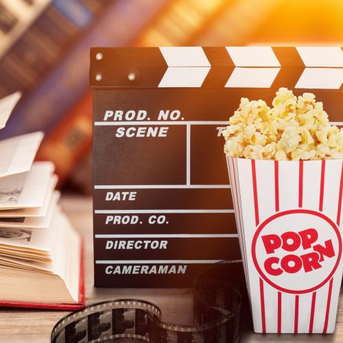stock photo of a book, movie prop and popcorn