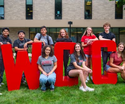 Students gathered around giant WCC letters outside