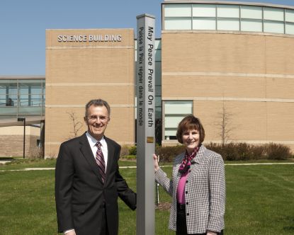 Dr. Sobek next to Peace Pole