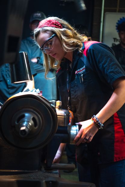 Cayla Fuechsl, Instructor of Automotive Technology, working in a shop