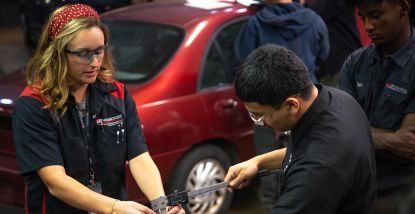 Cayla Fuechsl, Instructor of Automotive Technology, working with a student