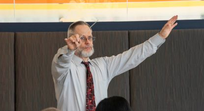 Dr. Mark Lathan conducting music class