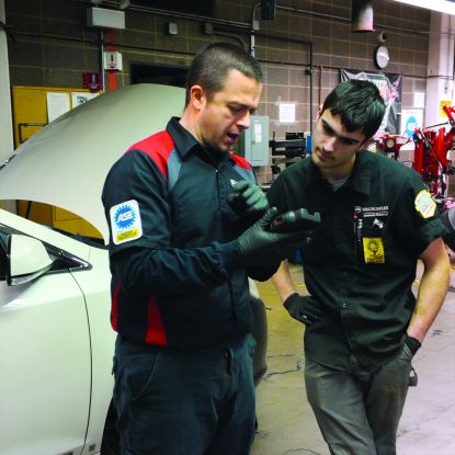 Guy Tiberio, III teaching student in Auto Tech class