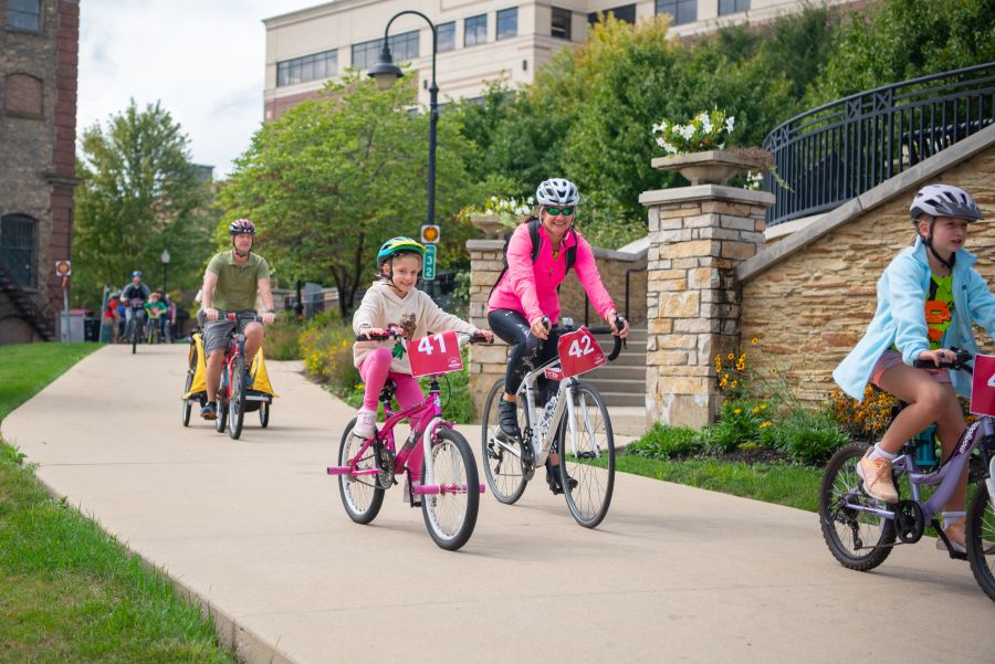 Bike riders on the path near Aurora Downtown campus